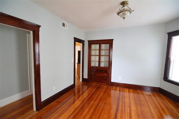 104 King Street, Unit 2 Boston, MA 02122 - Photo 13 of 29 wooden floor in an empty room with a window