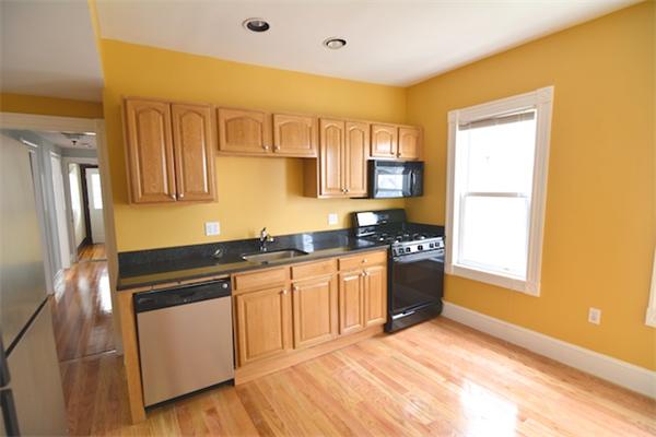 104 King Street, Unit 2 Boston, MA 02122 - Photo 17 of 29 a kitchen with stainless steel appliances granite countertop a stove a sink and a refrigerator
