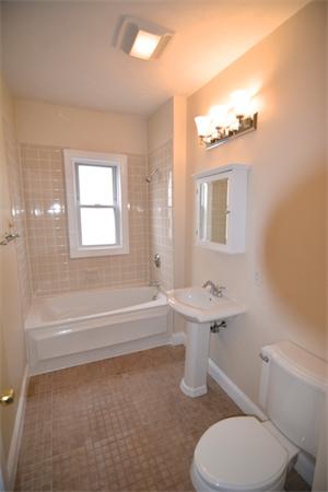 104 King Street, Unit 2 Boston, MA 02122 - Photo 18 of 29 a bathroom with a sink a toilet a mirror and bathtub