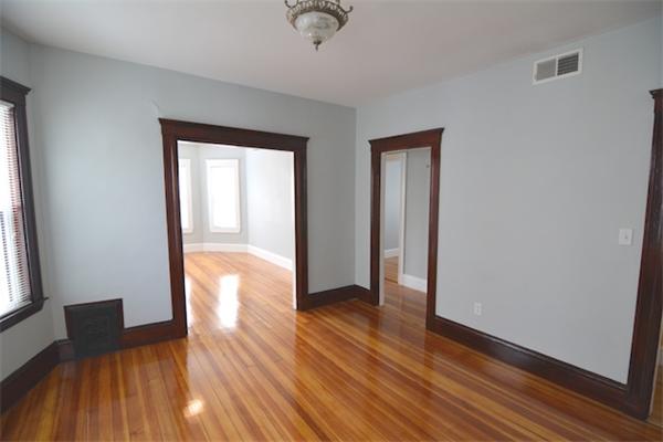 104 King Street, Unit 2 Boston, MA 02122 - Photo 22 of 29 an empty room with wooden floor and windows