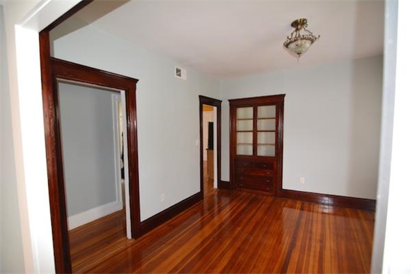 104 King Street, Unit 2 Boston, MA 02122 - Photo 3 of 29 wooden floor in an empty room with a window