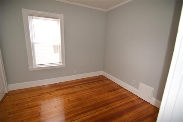 104 King Street, Unit 2 Boston, MA 02122 - Photo 4 of 29 wooden floor in an empty room with a window