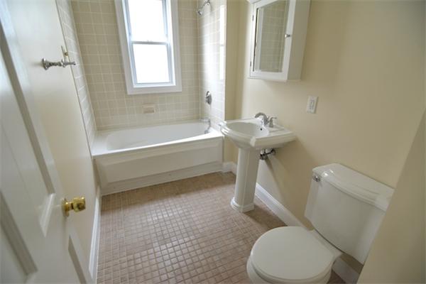 104 King Street, Unit 2 Boston, MA 02122 - Photo 6 of 29 a white toilet sitting next to a bath tub