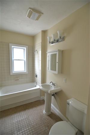 104 King Street, Unit 2 Boston, MA 02122 - Photo 7 of 29 a bathroom with a sink a toilet and bathtub