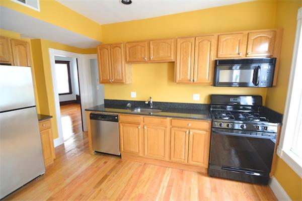 104 King Street, Unit 2 Boston, MA 02122 - Photo 8 of 29 a kitchen with stainless steel appliances granite countertop a stove a sink and a refrigerator