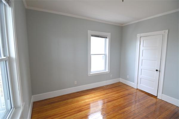 104 King Street, Unit 2 Boston, MA 02122 - Photo 9 of 29 an empty room with wooden floor and windows