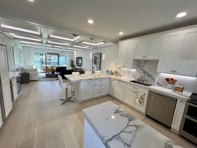 a kitchen with a sink cabinets and window