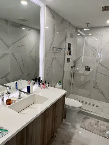 a bathroom with a sink double vanity and toilet