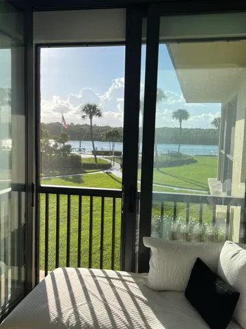 a view of a glass door of the house from a balcony