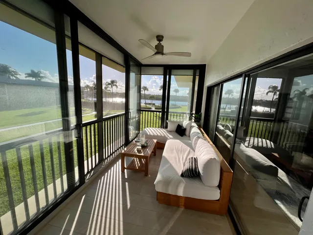 a bedroom with furniture and a large window
