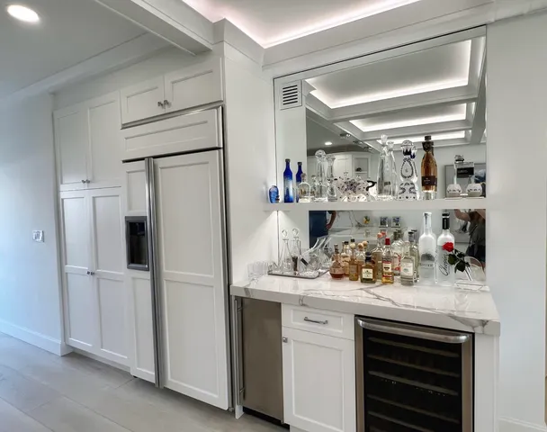 a kitchen with refrigerator and cabinets