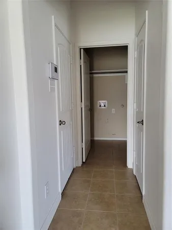 a view of a hallway with wooden shelves