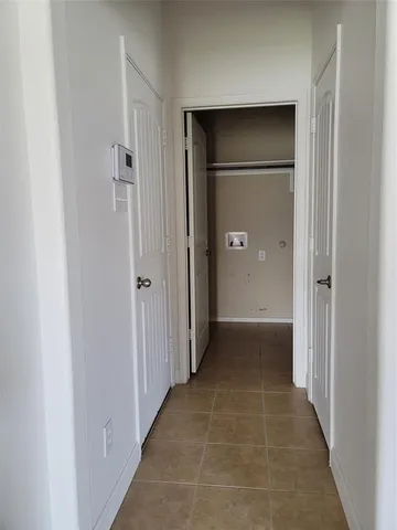 a view of a hallway with wooden shelves