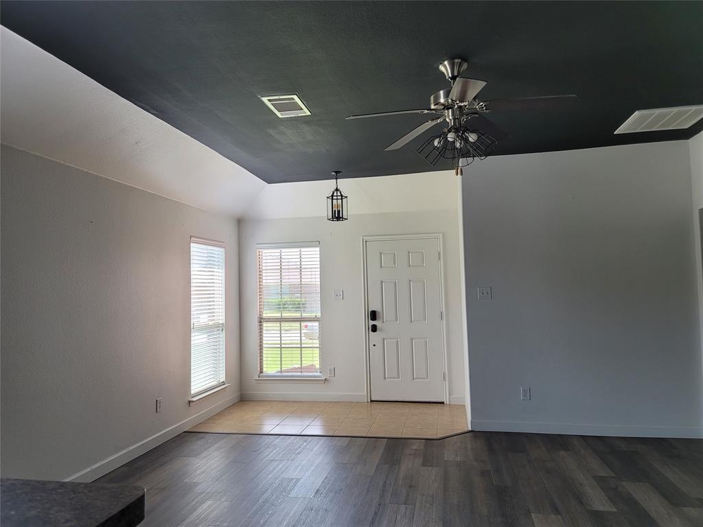 121 Chalk Road Anna, TX 75409 - Photo 14 of 22 an empty room with wooden floor fan and windows