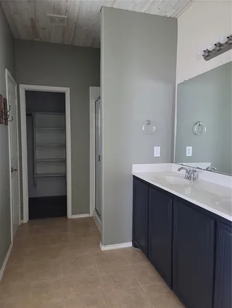 a bathroom with a double vanity sink and mirror