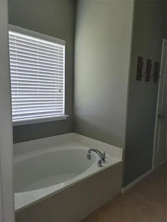 a white bath tub sitting next to a window