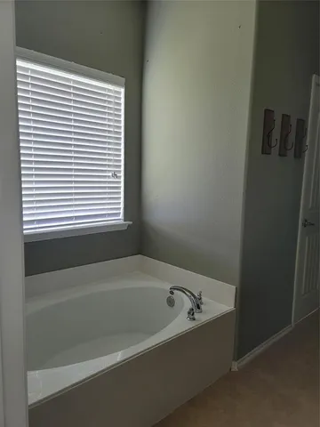a white bath tub sitting next to a window