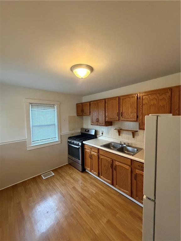 20 North Pine Street Ellsworth, PA 15314 - Photo 6 of 7 a kitchen with stainless steel appliances granite countertop a stove a sink and a refrigerator