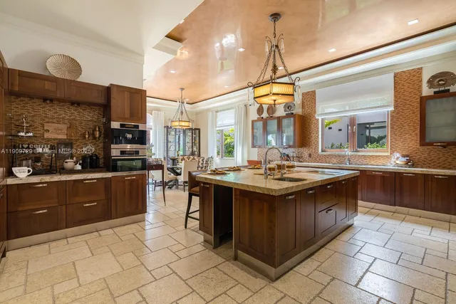 a kitchen with a stove sink and cabinets