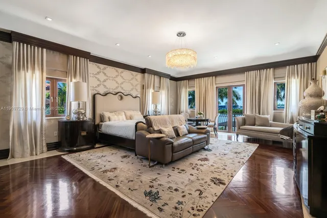 a living room with fireplace furniture and a chandelier