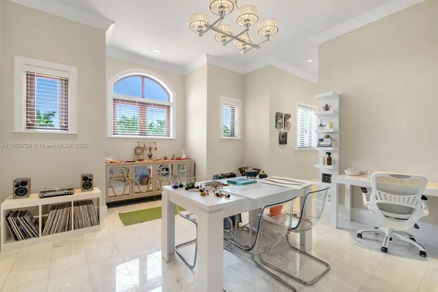 a spacious bedroom with a large bed and a chandelier