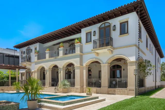 a view of a white house with outdoor seating