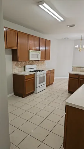 a kitchen with stainless steel appliances granite countertop a sink and a stove top oven