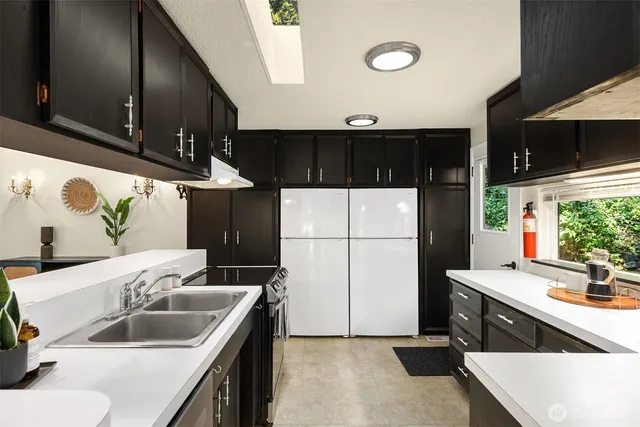 a kitchen with a sink and a refrigerator