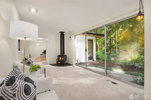 a bedroom with furniture and a large window