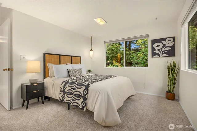 a bedroom with a bed and a window