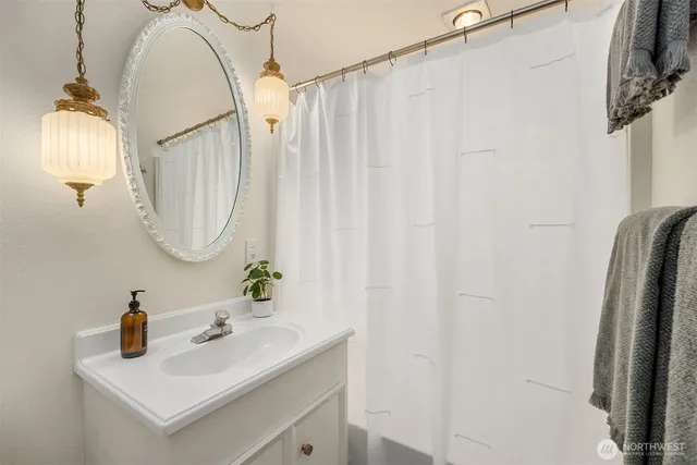a bathroom with a sink vanity and a mirror