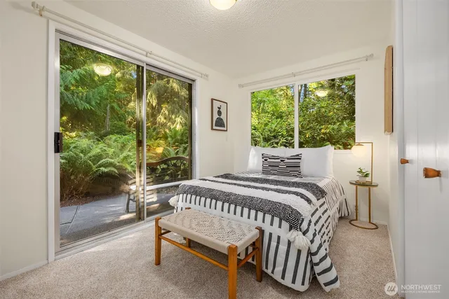 a bedroom with a bed and a large window