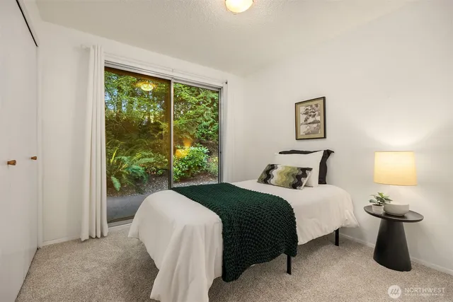 a bedroom with a bed lamp and window