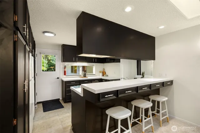 a kitchen with a stove a sink and a refrigerator