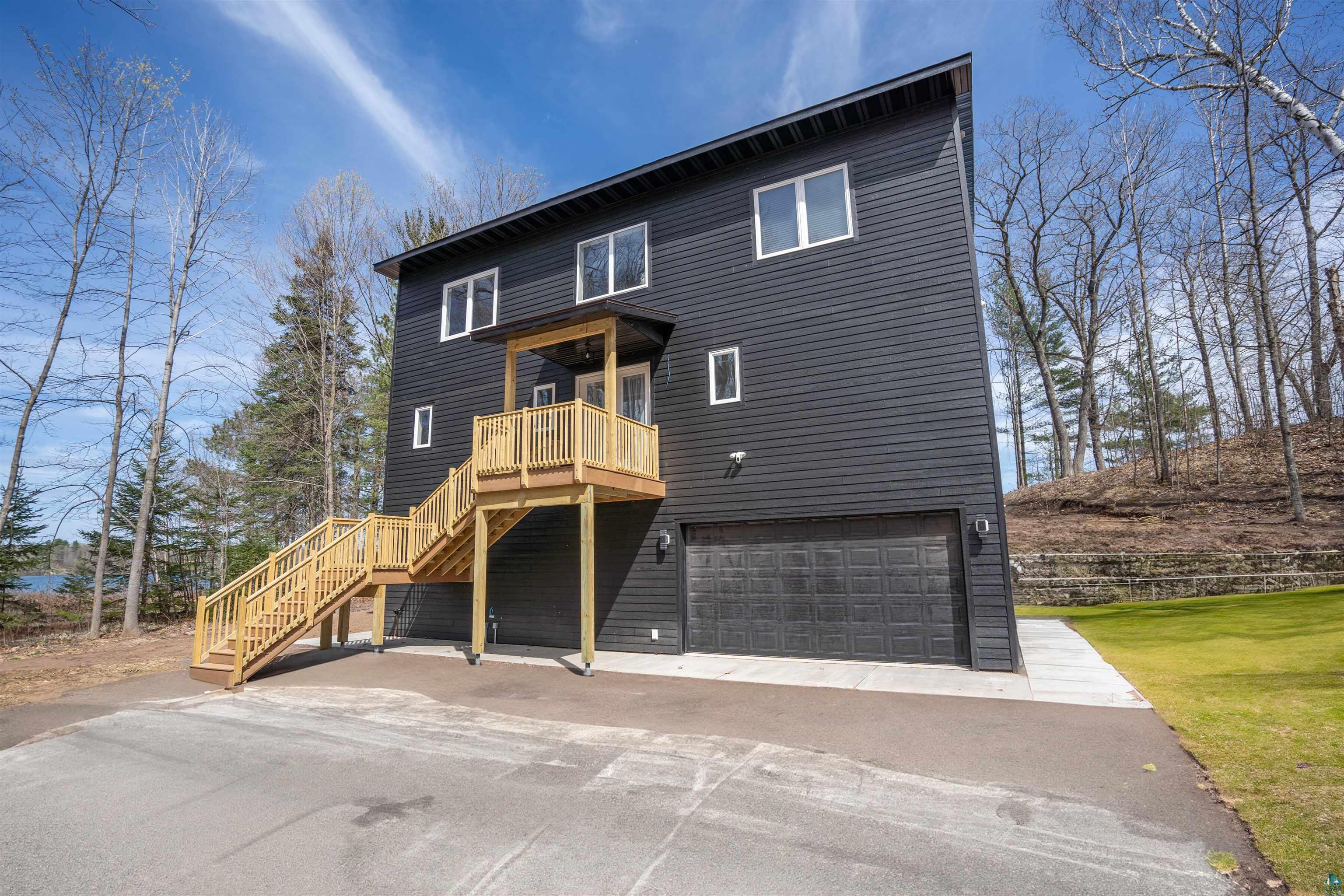 2000 West Chub Lake Road Carlton, MN 55718 - Photo 25 of 30 Modern multi-story residence featuring dark horizontal siding and contrasting white window frames