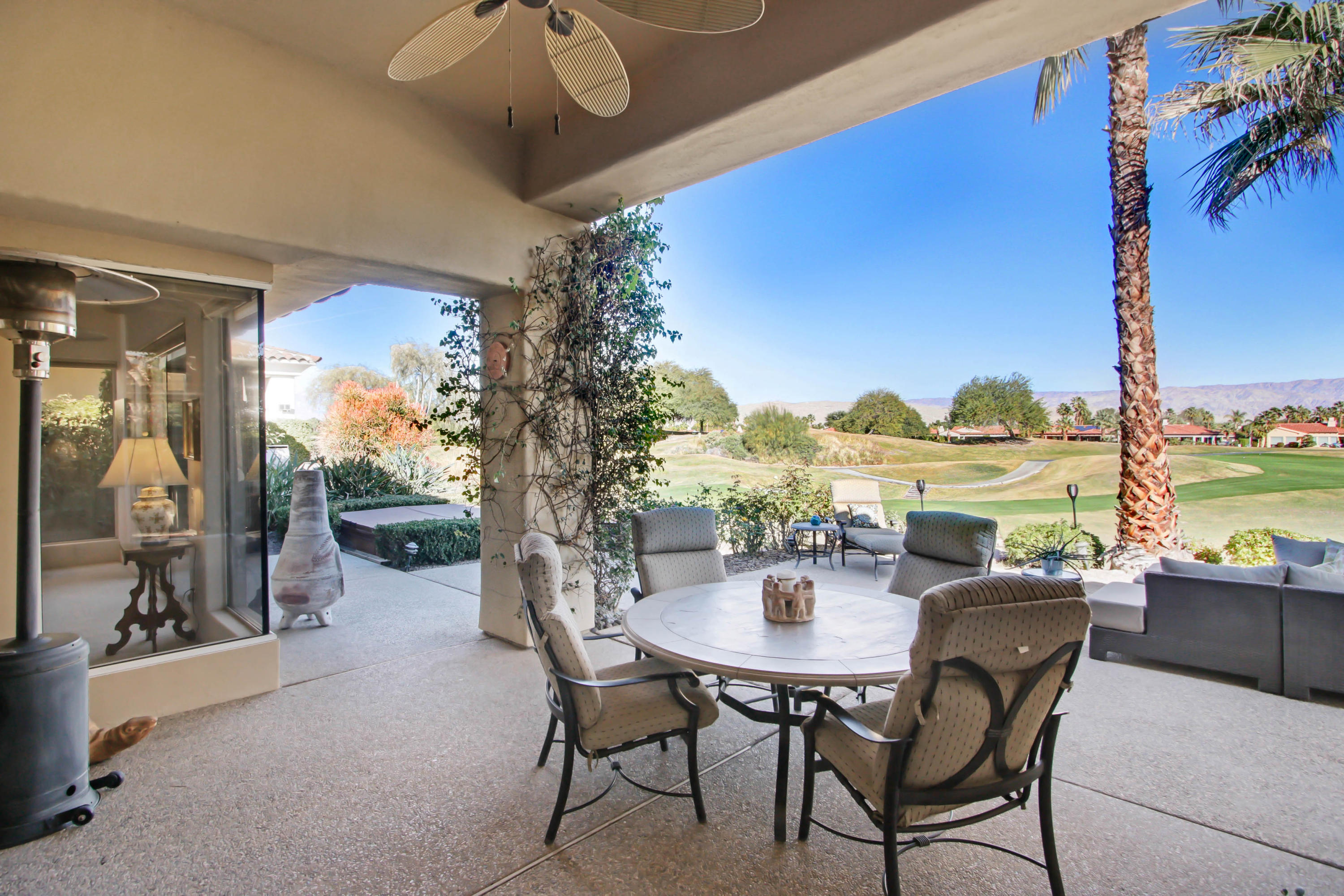 122 Loch Lomond Road Rancho Mirage, CA 92270 - Photo 22 of 34 a dining room with furniture and a floor to ceiling window