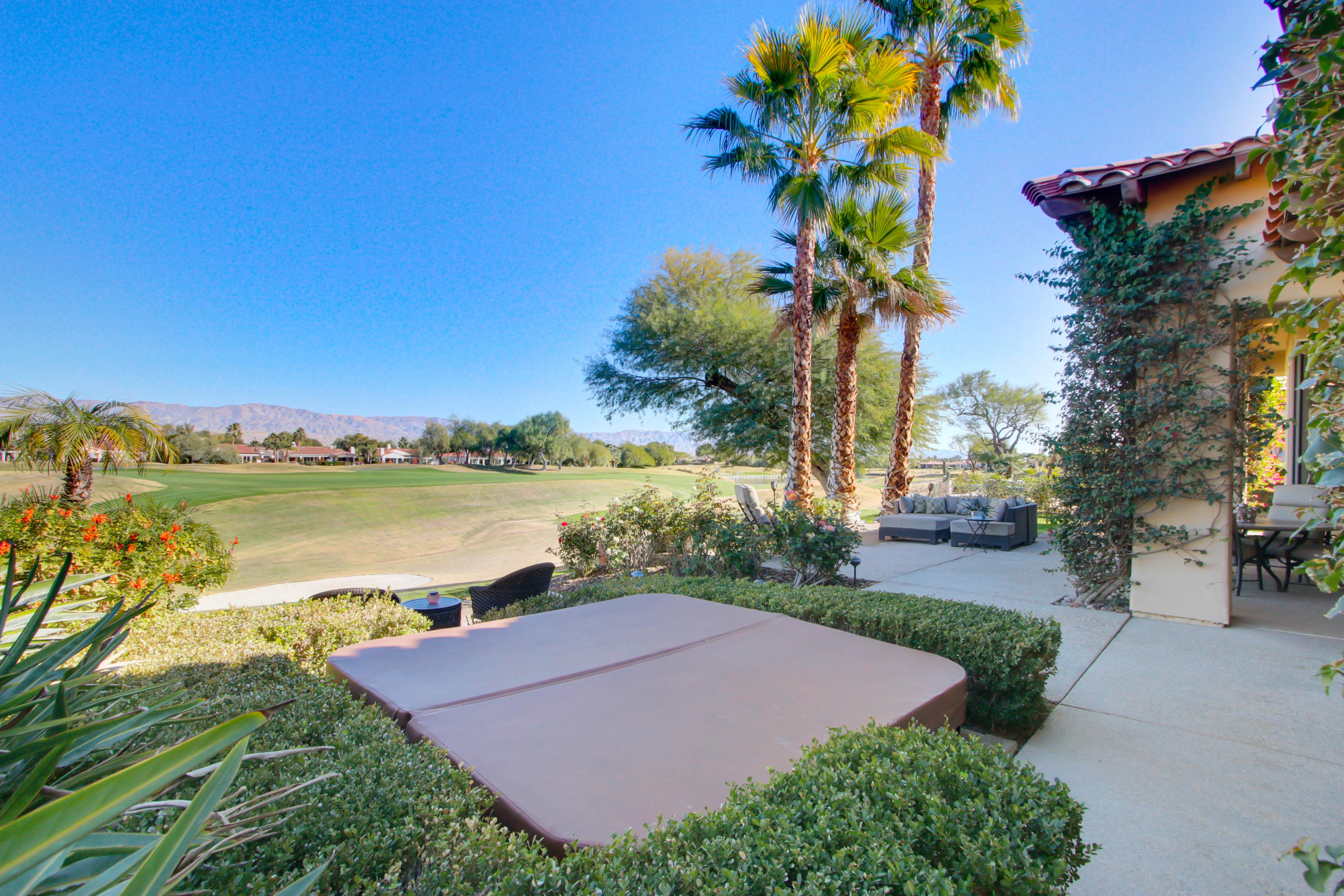 122 Loch Lomond Road Rancho Mirage, CA 92270 - Photo 24 of 34 a view of a lake with a house in the background