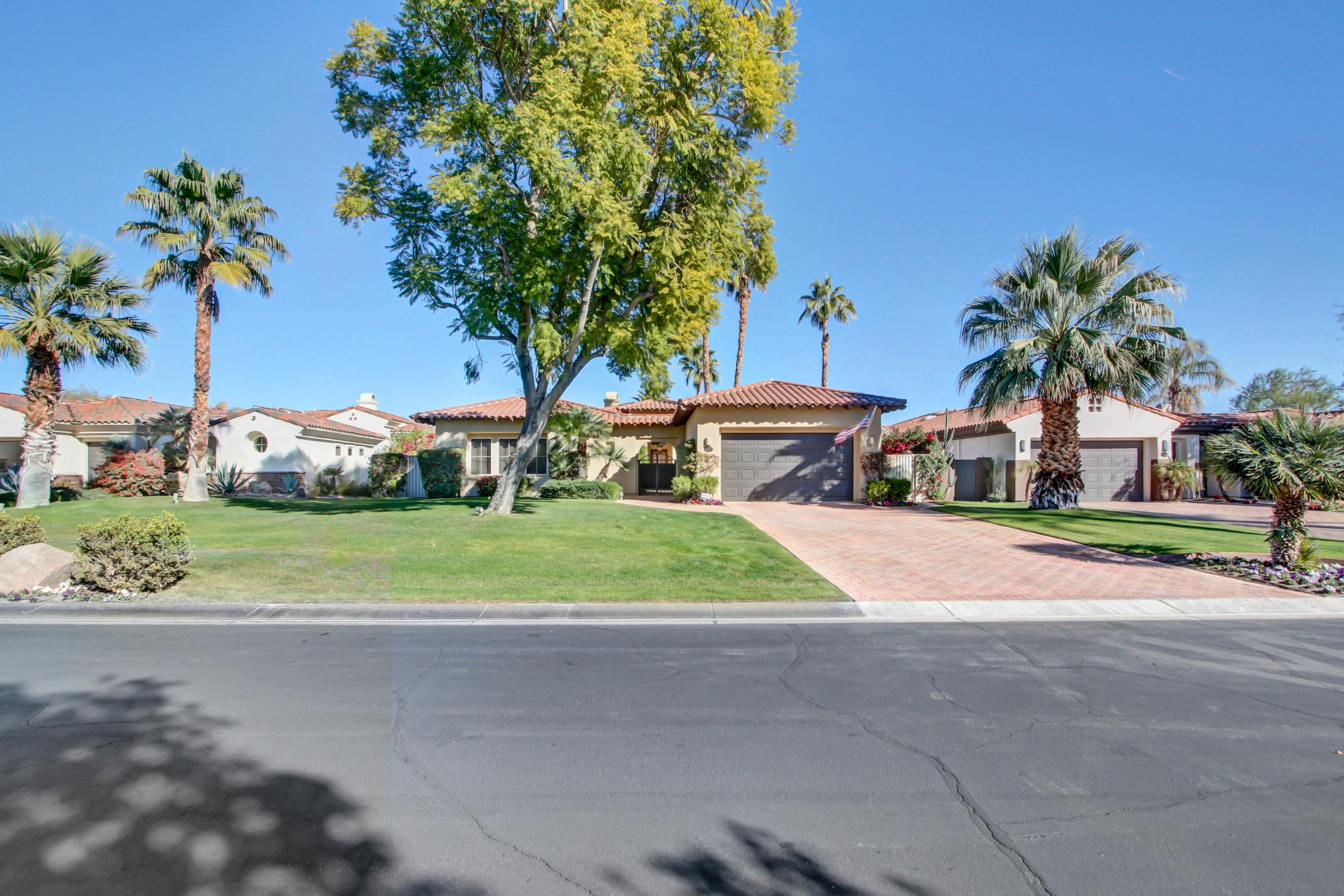 122 Loch Lomond Road Rancho Mirage, CA 92270 - Photo 4 of 34 a front view of a house with garden and parking space