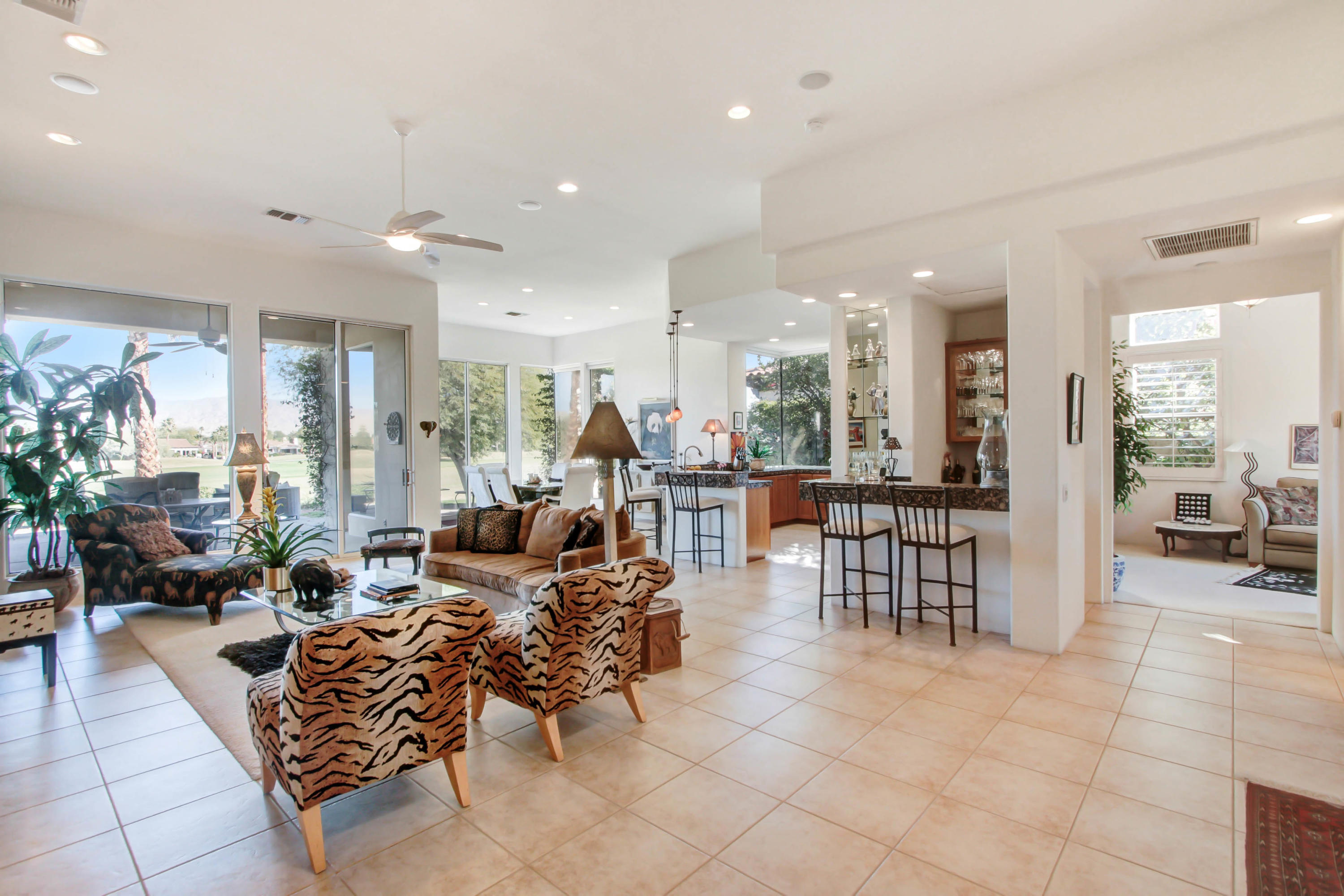 122 Loch Lomond Road Rancho Mirage, CA 92270 - Photo 6 of 34 a living room with furniture a large window and chairs