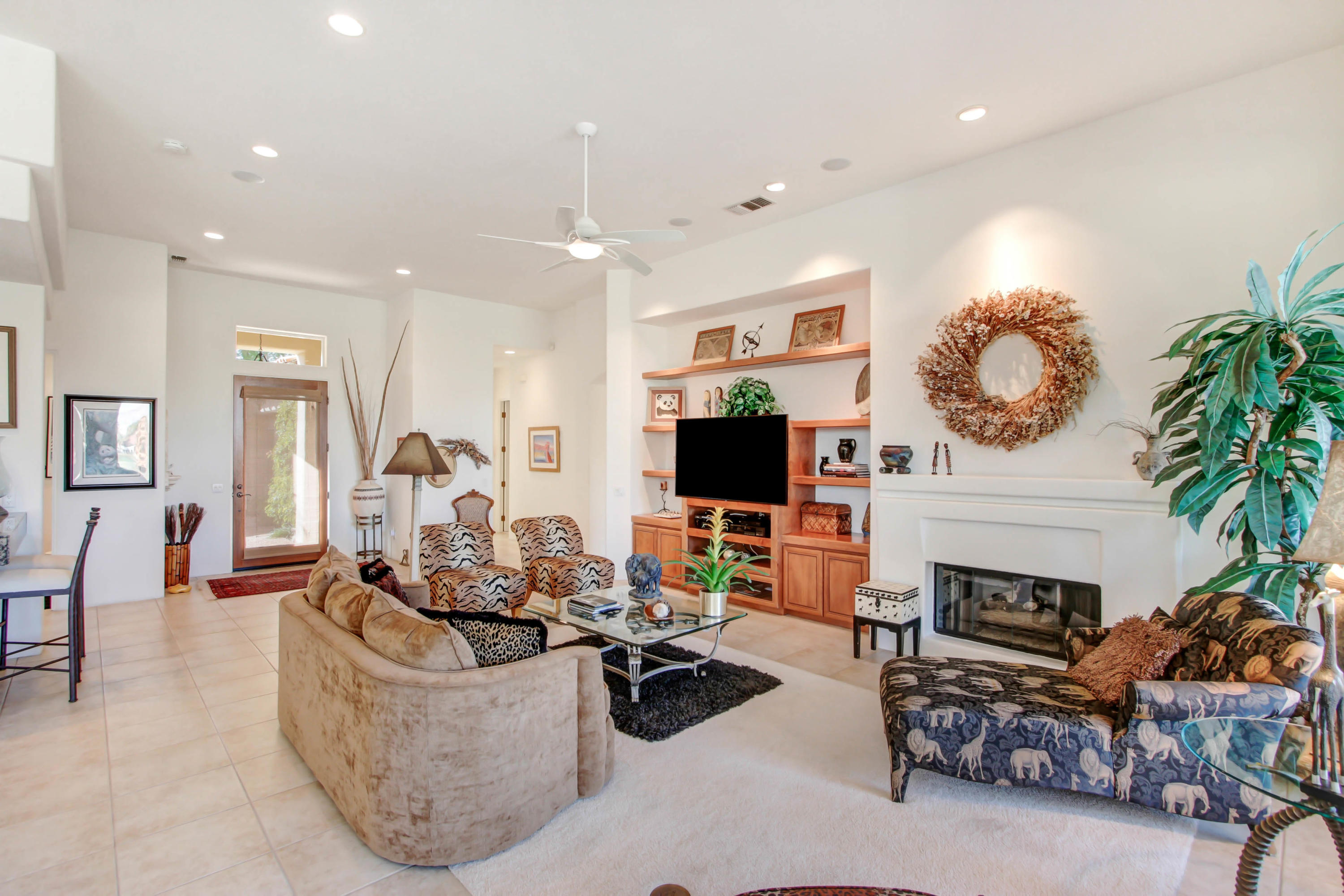 122 Loch Lomond Road Rancho Mirage, CA 92270 - Photo 9 of 34 a living room with fireplace furniture and a flat screen tv