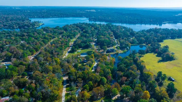 an aerial view of a houses with a yard