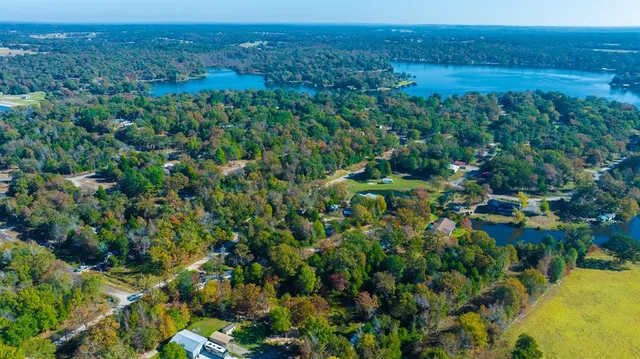 an aerial view of a houses with a yard