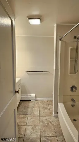 a bathroom with a tub a toilet and a shower