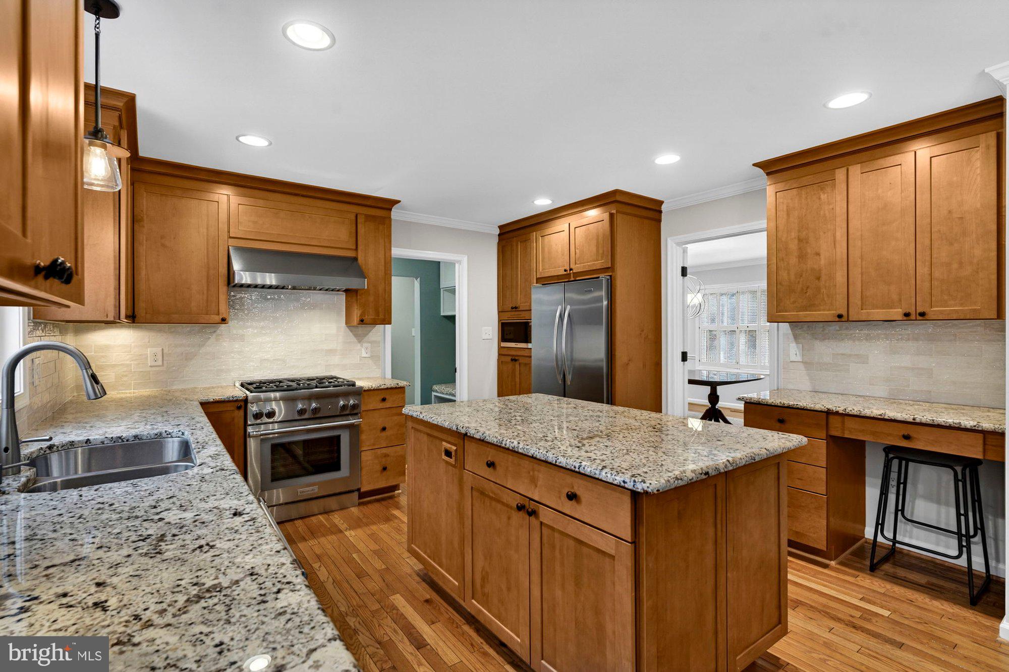 930 Park Street Vienna, VA 22180 - Photo 20 of 83 a kitchen with stainless steel appliances granite countertop a stove a sink and a refrigerator