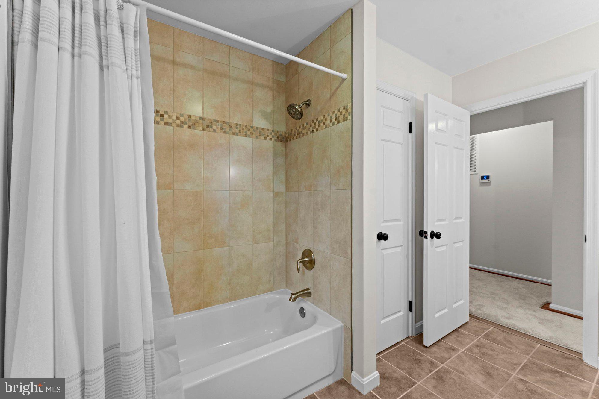930 Park Street Vienna, VA 22180 - Photo 55 of 83 a bathroom with a shower and a bath tub