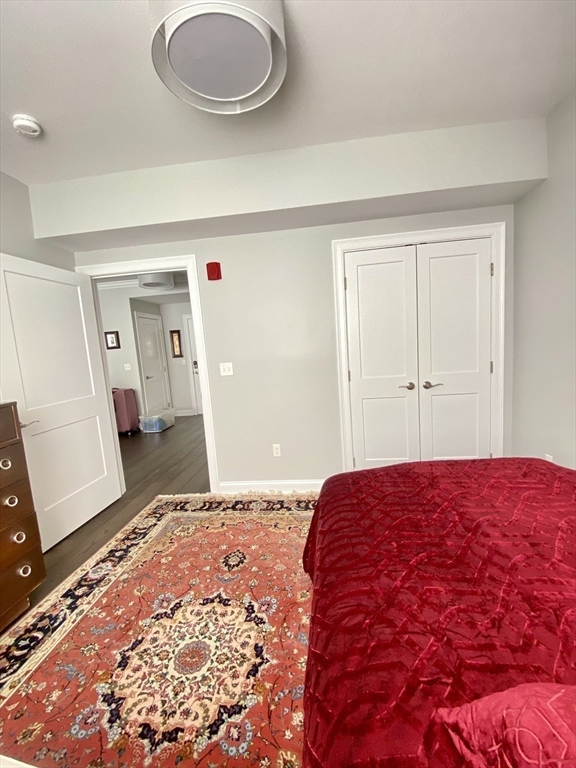 635 Old Post Road, Unit 2203 Sharon, MA 02067 - Photo 15 of 40 a bedroom with a bed and a mirror