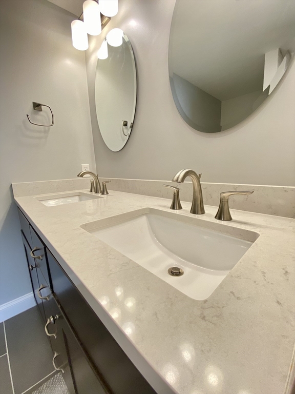635 Old Post Road, Unit 2203 Sharon, MA 02067 - Photo 23 of 40 a bathroom with a sink and a mirror