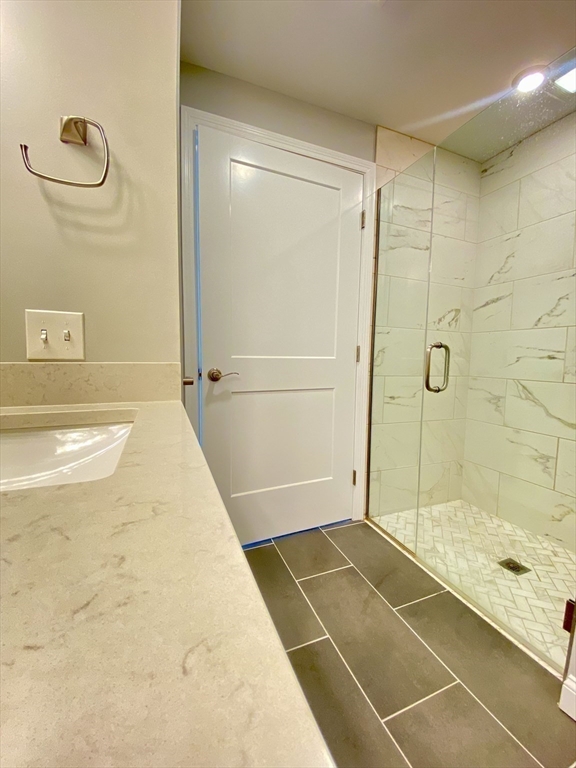 635 Old Post Road, Unit 2203 Sharon, MA 02067 - Photo 24 of 40 a bathroom with a bathtub and a shower