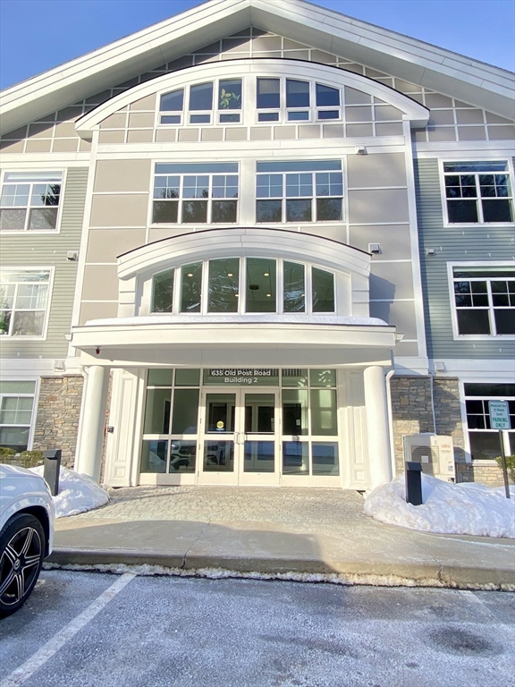 635 Old Post Road, Unit 2203 Sharon, MA 02067 - Photo 33 of 40 a front view of a house with a parking space
