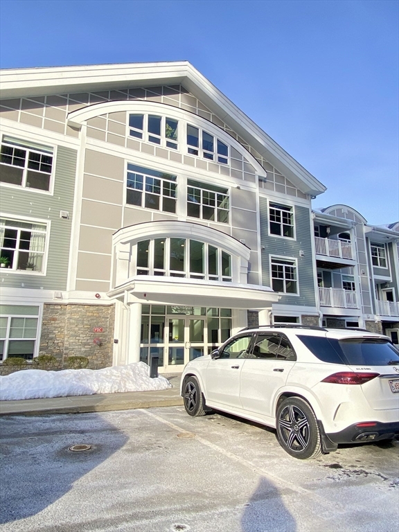 635 Old Post Road, Unit 2203 Sharon, MA 02067 - Photo 37 of 40 a front view of a residential building with parking space